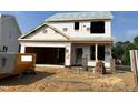 Two-story new construction home shows framing, windows and garage door pre-install, awaiting finishing touches at 183 W Saltgrass Ln, Smithfield, NC 27577