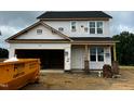 Two-story home under construction with an attached two-car garage and a black shingle roof at 183 W Saltgrass Ln, Smithfield, NC 27577