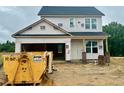 Two-story home under construction with visible frame and building materials, showcasing the early stages of construction at 183 W Saltgrass Ln, Smithfield, NC 27577