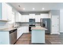 Bright kitchen with white cabinets, stainless steel appliances, and a center island at 183 W Saltgrass Ln, Smithfield, NC 27577