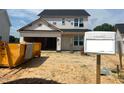 Two-story home featuring an attached garage, covered entry, and landscaping during the construction phase at 189 W Saltgrass Ln, Smithfield, NC 27577