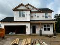 New two-story home shows construction progress with visible framing and garage at 189 W Saltgrass Ln, Smithfield, NC 27577