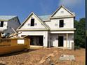 New home under construction featuring a two-car garage and covered front entry at 197 W Saltgrass Ln, Smithfield, NC 27577
