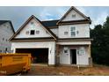 Two-story home showcasing its exterior elevation with a two-car garage under construction at 197 W Saltgrass Ln, Smithfield, NC 27577