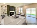 Bright living room with fireplace and views of the backyard at 197 W Saltgrass Ln, Smithfield, NC 27577