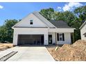 New single-Gathering home with attached garage, concrete driveway, and classic black and white color scheme at 201 W Saltgrass Ln, Smithfield, NC 27577
