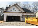 New construction home shows a two-car garage, a covered entrance and construction materials at 201 W Saltgrass Ln, Smithfield, NC 27577