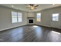Bright living room boasts luxury vinyl plank floors, a fireplace, and large windows for natural light at 201 W Saltgrass Ln, Smithfield, NC 27577