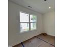 Bright bedroom with natural light from a double-hung window and an electrical outlet at 211 W Saltgrass Ln, Smithfield, NC 27577