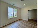 Bright bedroom with plush carpeting, neutral walls, and a window offering natural light and neighborhood views at 211 W Saltgrass Ln, Smithfield, NC 27577