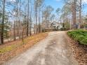 Charming home with a long driveway and mature trees, offering a sense of privacy and tranquility at 228 Sagamore Dr, Louisburg, NC 27549