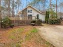 Inviting home with a spacious deck, stone chimney, and well-maintained landscaping, nestled among mature trees at 228 Sagamore Dr, Louisburg, NC 27549