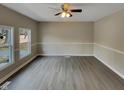Spacious living room with hardwood floors and natural light from multiple windows at 2412 Little John Rd, Raleigh, NC 27610