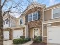 Desirable townhouse featuring stylish stonework, private garage, and verdant curb appeal at 2459 Memory Ridge Dr, Raleigh, NC 27606