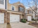 Attractive townhome exterior with brick accents, well-kept lawn, and convenient driveway at 2459 Memory Ridge Dr, Raleigh, NC 27606