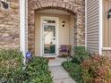Inviting front entrance with a brick archway, complemented by manicured landscaping and a cozy chair at 2459 Memory Ridge Dr, Raleigh, NC 27606