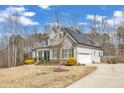 Lovely home with solar panels, featuring a long driveway, beautiful landscaping, and a well-maintained front yard at 330 Bridgeport Cir, Clayton, NC 27527