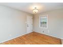 Bright bedroom with neutral walls, wood floors, and a large window at 3429 Dogwood Dr, Raleigh, NC 27604