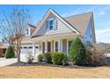 Well-maintained home showcasing manicured landscaping, stylish siding, and welcoming front porch at 345 Springtime Fields Ln, Wake Forest, NC 27587