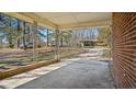 A glimpse of the home's brick exterior from the porch with vintage posts and view of a nearby car at 4018 Kilkenny Ave, Oxford, NC 27565