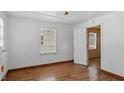 The empty bedroom boasts light walls, wood floors, a window, and a closet at 415 Cherry St, Oxford, NC 27565
