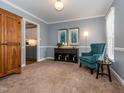 Comfortable living room showcasing stylish decor, soft lighting, and seamless flow to the kitchen at 4617 Atterbury Ct, Raleigh, NC 27604