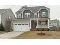 Charming two-story home with a covered front porch and two-car garage at 4821 Heathshire Dr, Raleigh, NC 27616