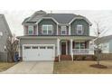 Charming two-story home with a covered front porch and two-car garage at 4821 Heathshire Dr, Raleigh, NC 27616