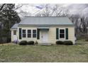 Charming home featuring a metal roof, complementary green shutters, and a well-maintained lawn at 510 Short W St, Hillsborough, NC 27278