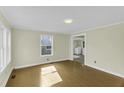 View of the living room with hardwood flooring leading to the laundry area at 510 Short W St, Hillsborough, NC 27278