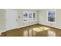 Bright living room with multiple windows providing ample natural light and hardwood flooring at 510 Short W St, Hillsborough, NC 27278