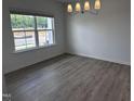 Bright dining room with a large window and modern chandelier, ready for elegant meals at 548 Jocund St # 15, Rolesville, NC 27571