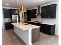 Modern kitchen with a large island, stainless steel appliances, and sleek cabinetry at 548 Jocund St # 15, Rolesville, NC 27571