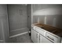 Modern bathroom with a tiled walk-in shower and vanity with gold pulls awaiting finishing touches at 564 Jocund St # 11, Rolesville, NC 27571