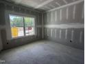 Bright, unfinished bedroom with a large window offering scenic views at 564 Jocund St # 11, Rolesville, NC 27571