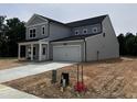 Charming two-story home with gray siding and a two-car garage, showcasing modern curb appeal at 564 Jocund St # 11, Rolesville, NC 27571