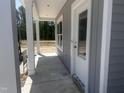 Inviting covered front porch with white columns and a gray exterior offers a warm welcome at 564 Jocund St # 11, Rolesville, NC 27571