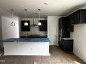 Modern kitchen featuring dark cabinets, a central island, and stainless steel appliances for culinary enthusiasts at 564 Jocund St # 11, Rolesville, NC 27571