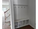 Bright mudroom with a built-in bench, cubbies, and hooks for organized storage near the entrance at 564 Jocund St # 11, Rolesville, NC 27571