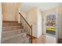 Bright foyer with parquet floors, carpeted stairs, and a view of the outdoors at 706 Collington Dr, Cary, NC 27511
