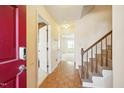 Inviting foyer with parquet floors and a staircase leading to the upper level at 706 Collington Dr, Cary, NC 27511