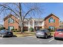 Exterior of a brick apartment building with white railing and green shutters at 723 Renshaw Ct, Cary, NC 27518