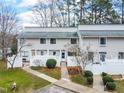 Aerial shot of well-maintained townhouses with white fences, walkways, and landscaped front yards at 7317 Sandy Creek Dr, Raleigh, NC 27615