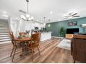 Open-concept living space features wood floors, modern lighting, and a neutral color palette at 7802 Flatrock Park Dr # 131, Knightdale, NC 27545