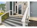 Close up of the entryway with seating and stone accents at 809 Handel Ln, Apex, NC 27502