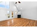 Spacious living room with vaulted ceilings, fireplace, and large windows at 809 Handel Ln, Apex, NC 27502