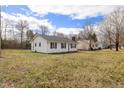Quaint single-story home featuring black shutters and a clean, white exterior on a spacious lot at 825 Parkwood St, Burlington, NC 27215