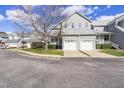 Charming townhouse featuring a two-car garage and beautifully landscaped front yard at 8310 Hempshire Pl # 106, Raleigh, NC 27613