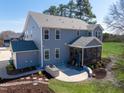 Backyard features a patio with outdoor kitchen area, screened-in porch, and large yard at 8424 Brady Pointe Rd, Fuquay Varina, NC 27526