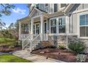 Close up of front porch and steps that feature stone accents and well-maintained landscaping at 8424 Brady Pointe Rd, Fuquay Varina, NC 27526